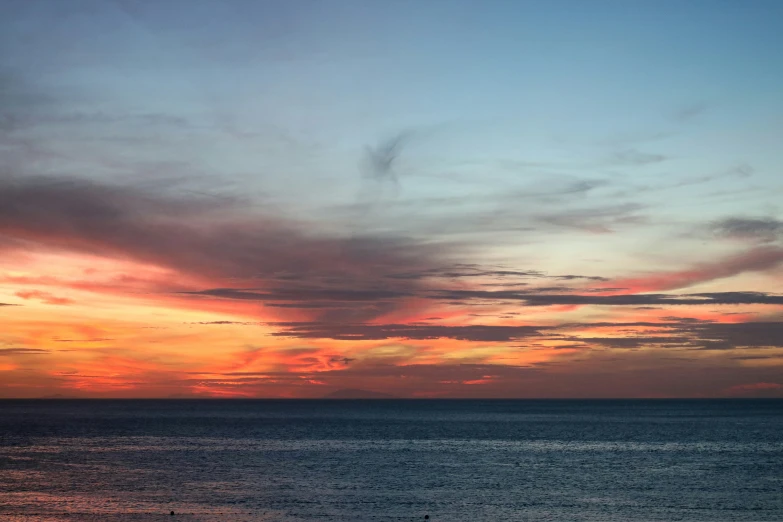 the sky is colored with pink and blue clouds