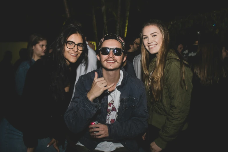 two men are posing with the other women at a party