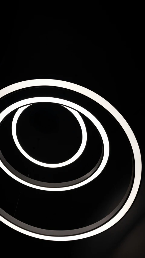 a circular light on the floor with a black background