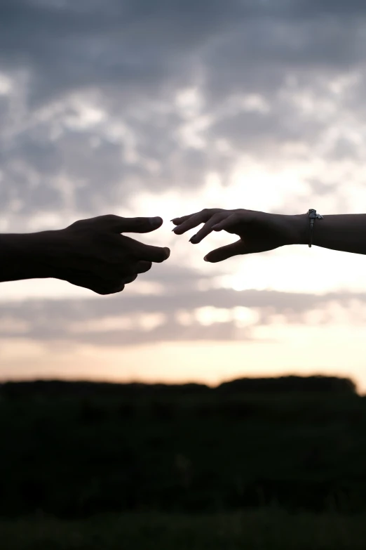 a person reaching out to another hand