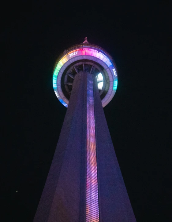 the rainbow light reflects on the tower's tower at night