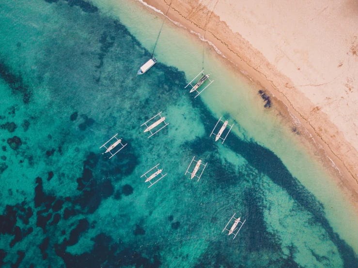 some small boats and sand near the ocean