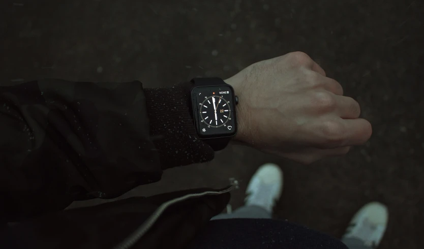 a person holding a clock on their hand