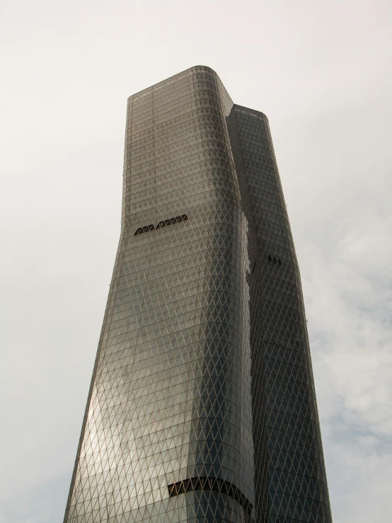 a glass tower that has a clock at the top