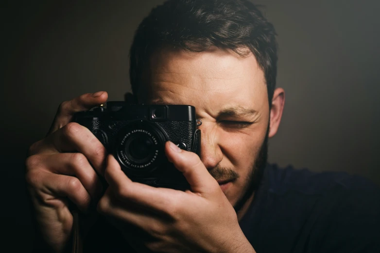 a man takes a pograph with his camera