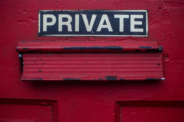 a red door with the words private mounted on it