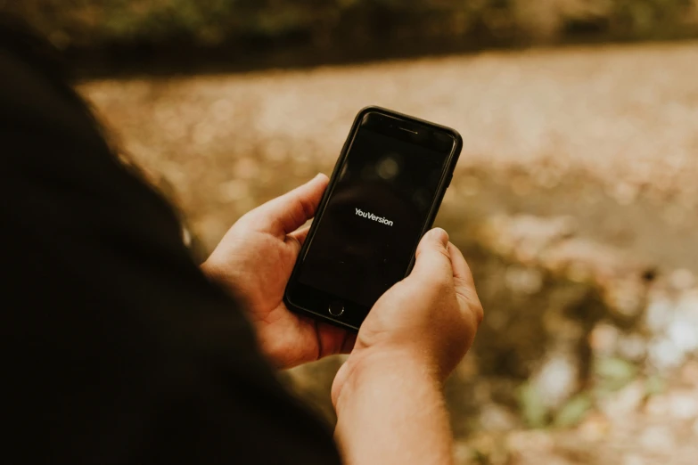 someone holding up a cell phone in their hands