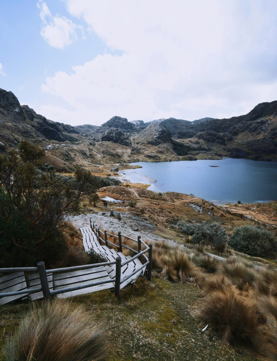 a view of a mountain lake and wooden fence