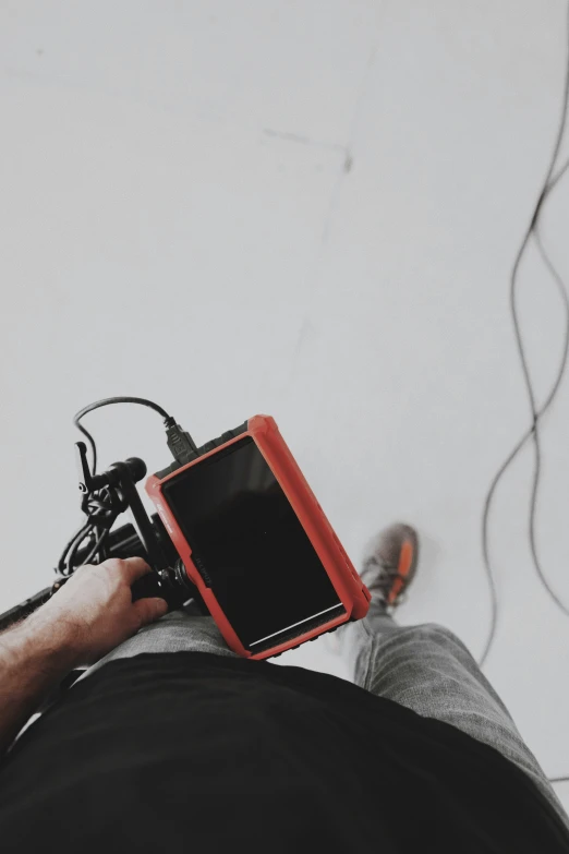 a person sitting down with a camera strapped to their back