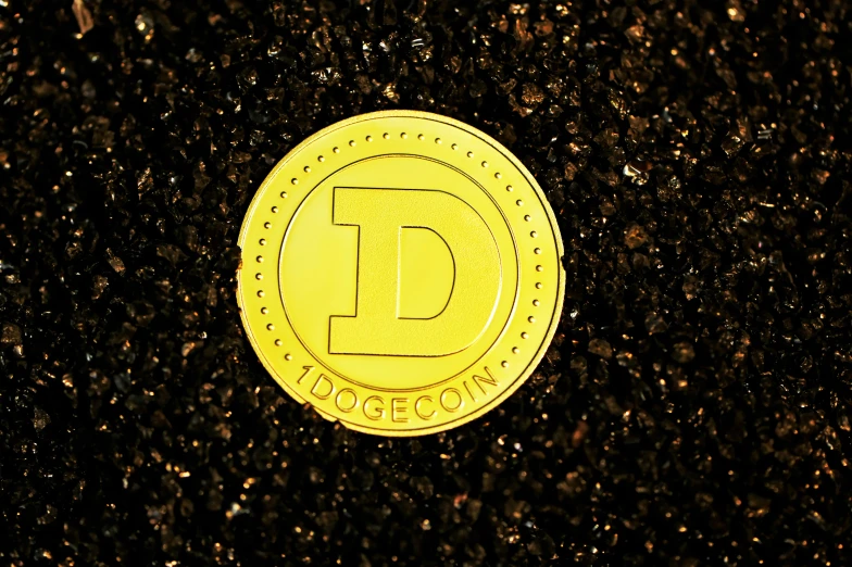 this is a yellow coin that is written d