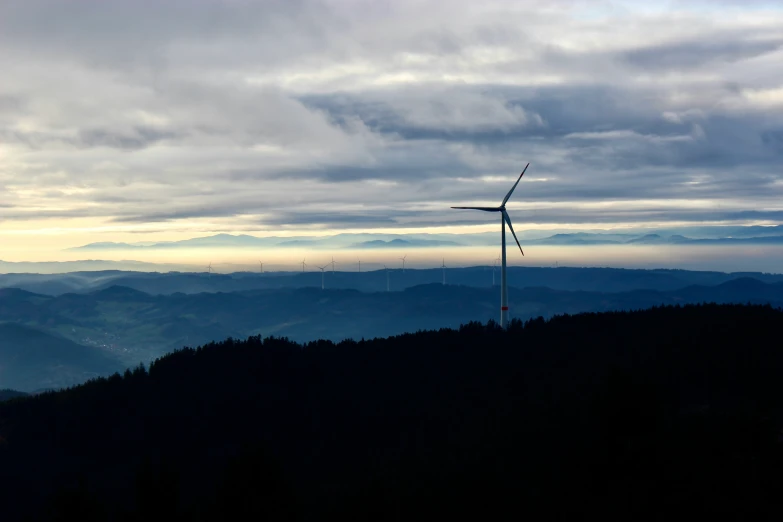 there is a wind turbine on a tall pole