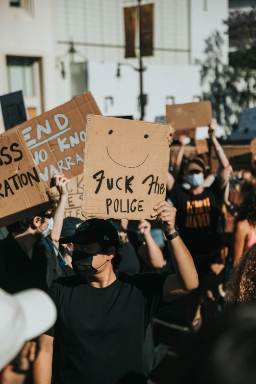 a man holds up signs at a protest