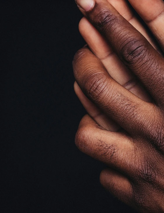 a hand reaching up toward the camera in dark