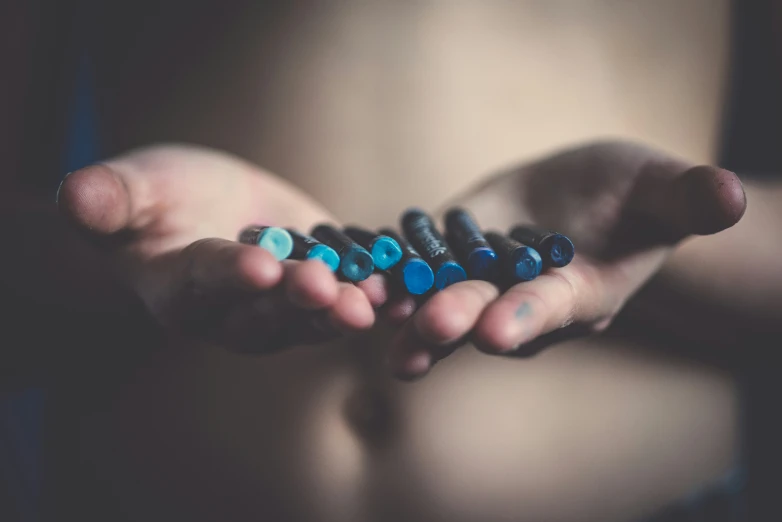 the blue pills are in someone's hands