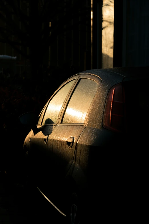 a small black car parked on the side of the street