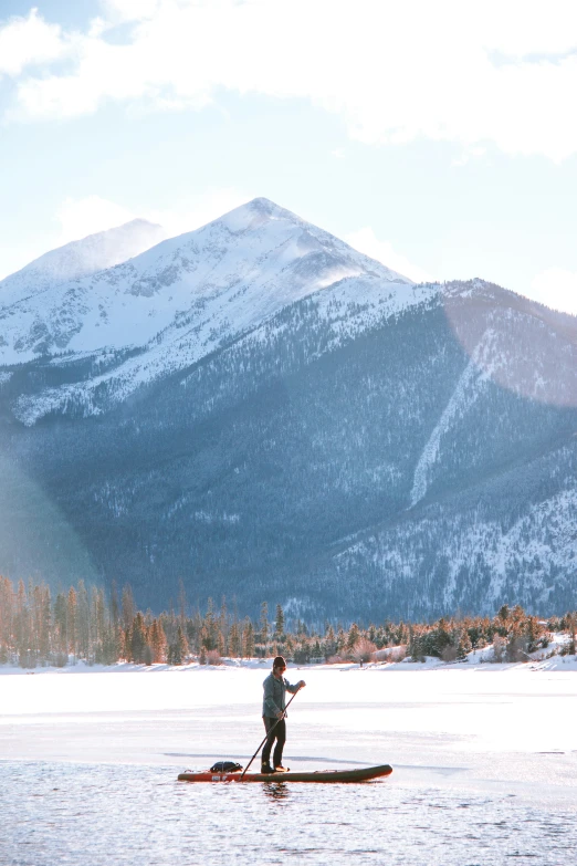 a man riding on top of a snow covered boat