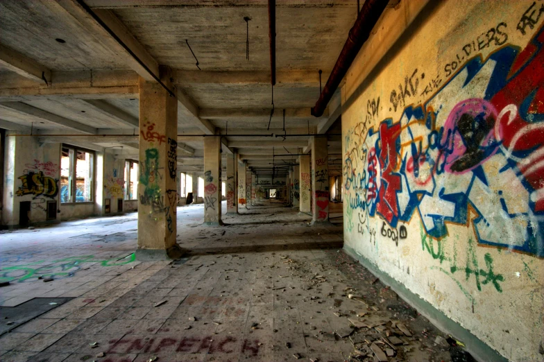 a hallway that has graffiti all over the walls