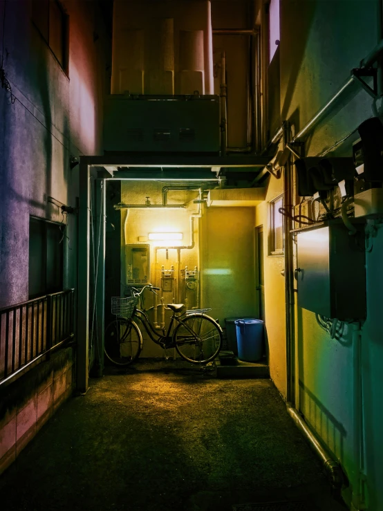 a very dark hallway with some bikes and a light on