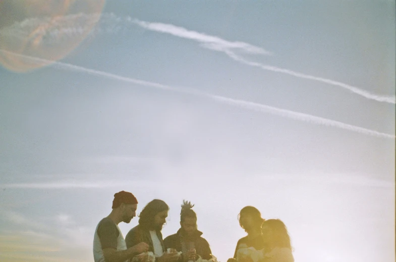 three people standing with one holding their arms out