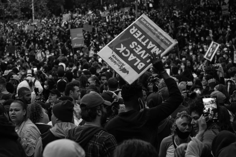 a group of people holding up signs at a demonstration