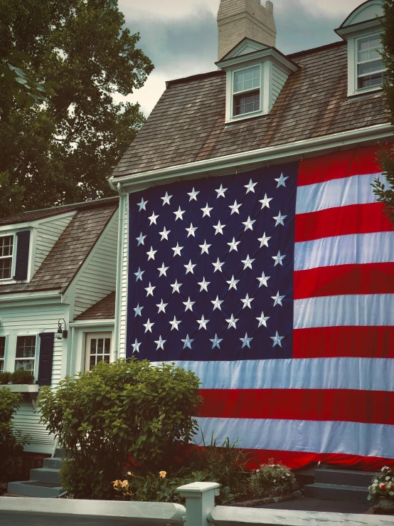 large flag hanging off the side of a house