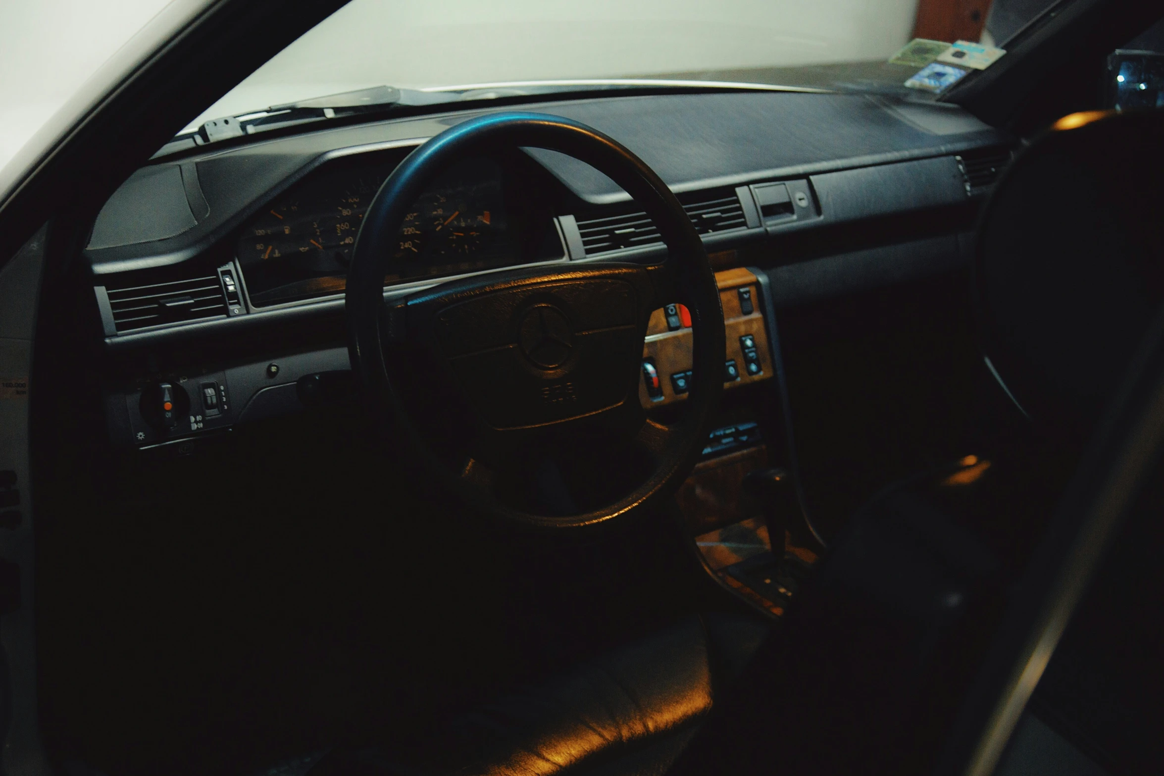 a car dashboard with a steering wheel and dashboard lights