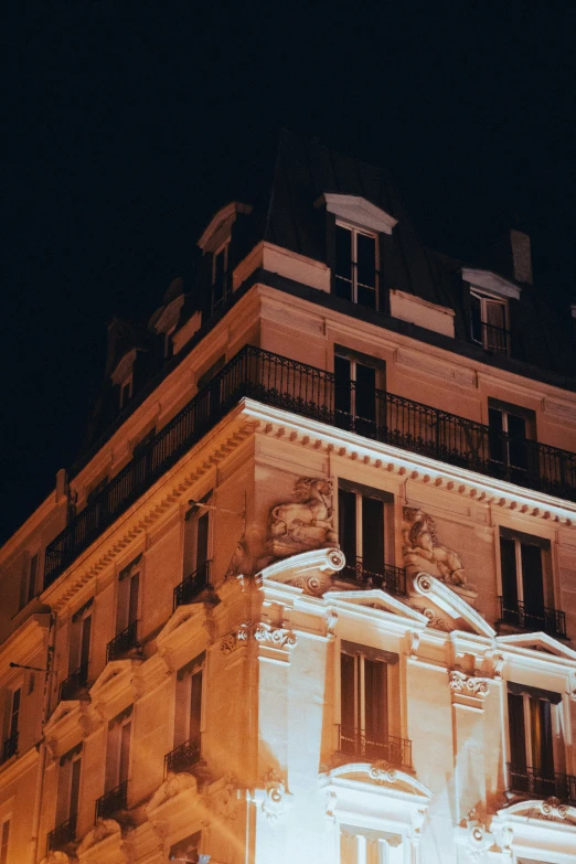 the building at night has windows and balconies