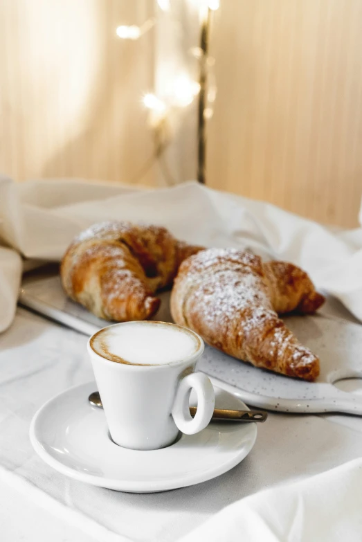 pastries on a plate and a cup of coffee on the table