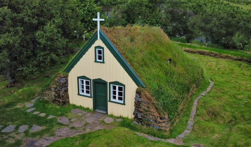 an aerial po shows a small house with a cross on it's roof