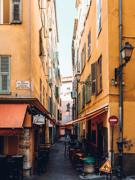 an old street lined with yellow buildings