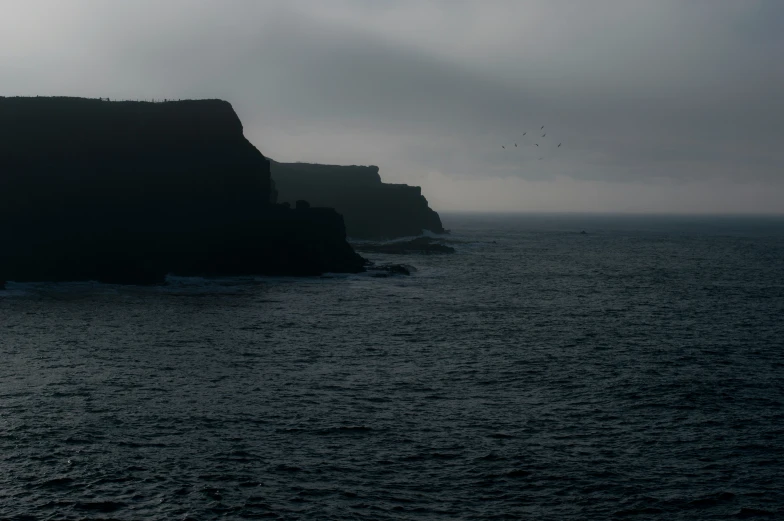 the cliffs are surrounded by a deep blue ocean