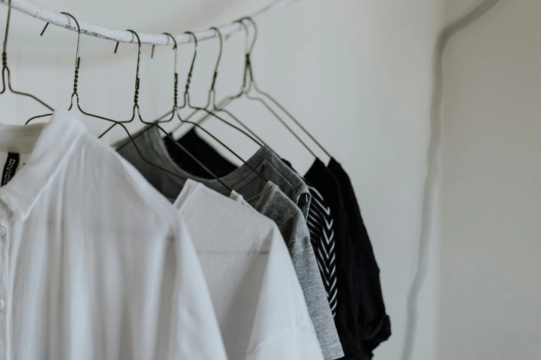 several t shirts hanging in a row on a clothes rack