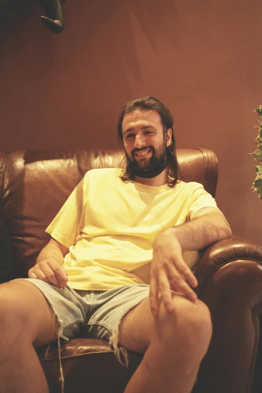 a man sitting in a leather chair smiling