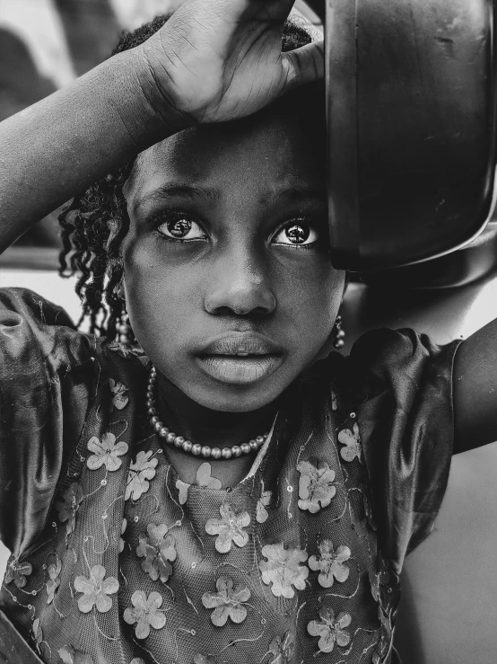 an african american girl is holding a pan