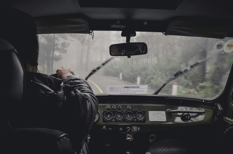 a driver on the road in a truck is looking out the window