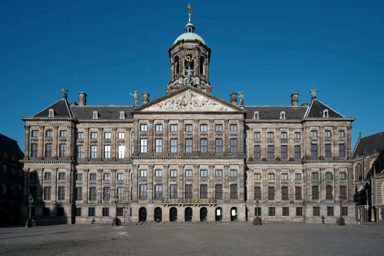 a large brown building with a clock tower in the middle