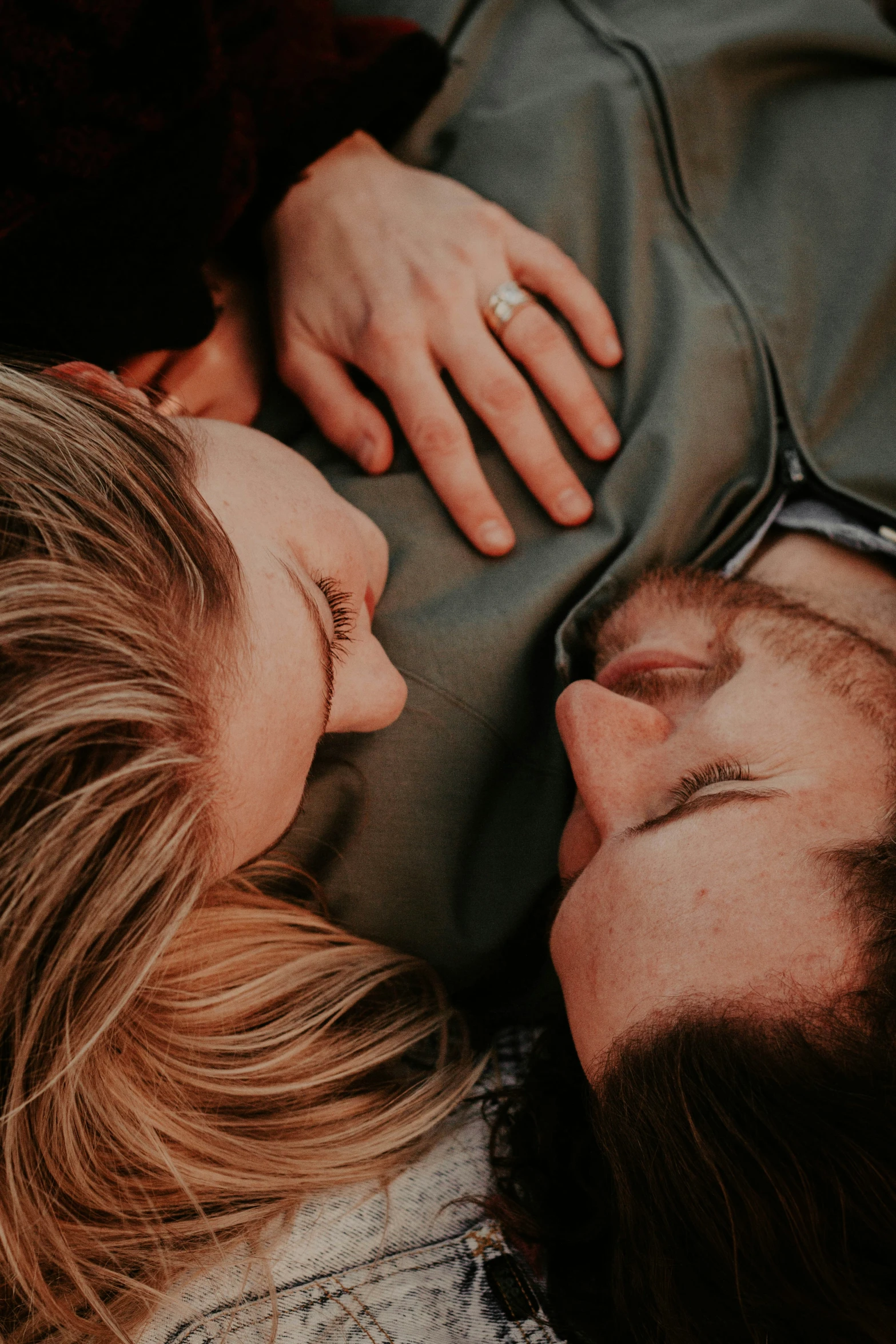 two people laying down with their heads close to each other