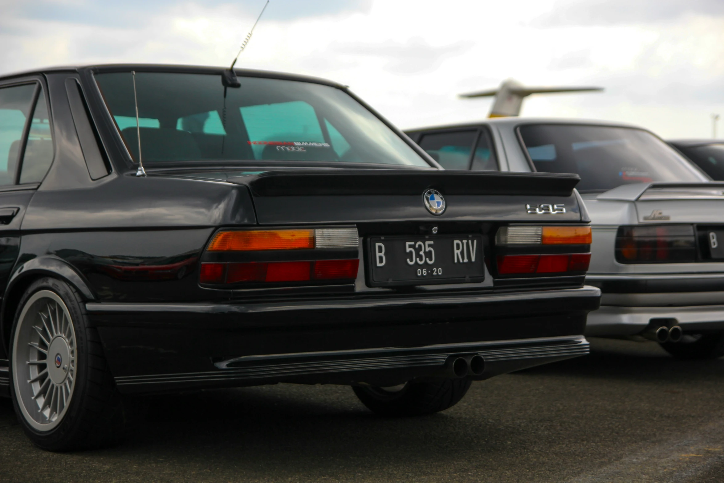 a bmw car sitting in a lot with other cars