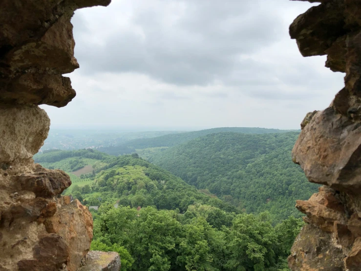 a window on some very big rocks with trees