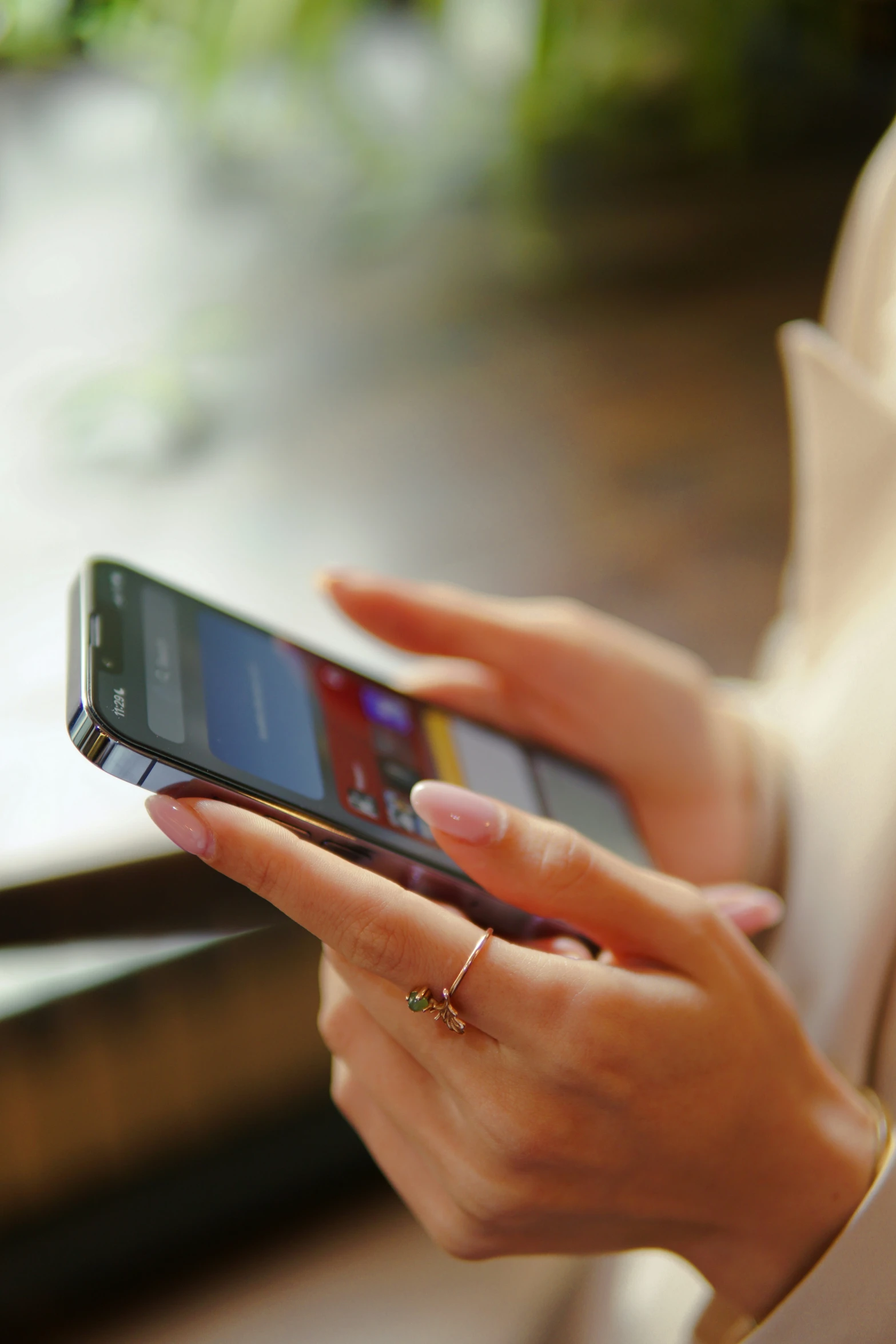 a woman holding an open cell phone with her hands