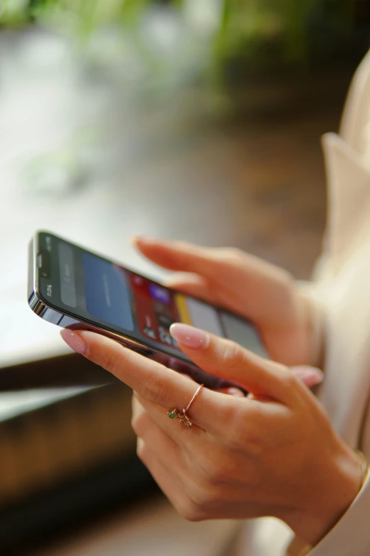 a woman holding an open cell phone with her hands