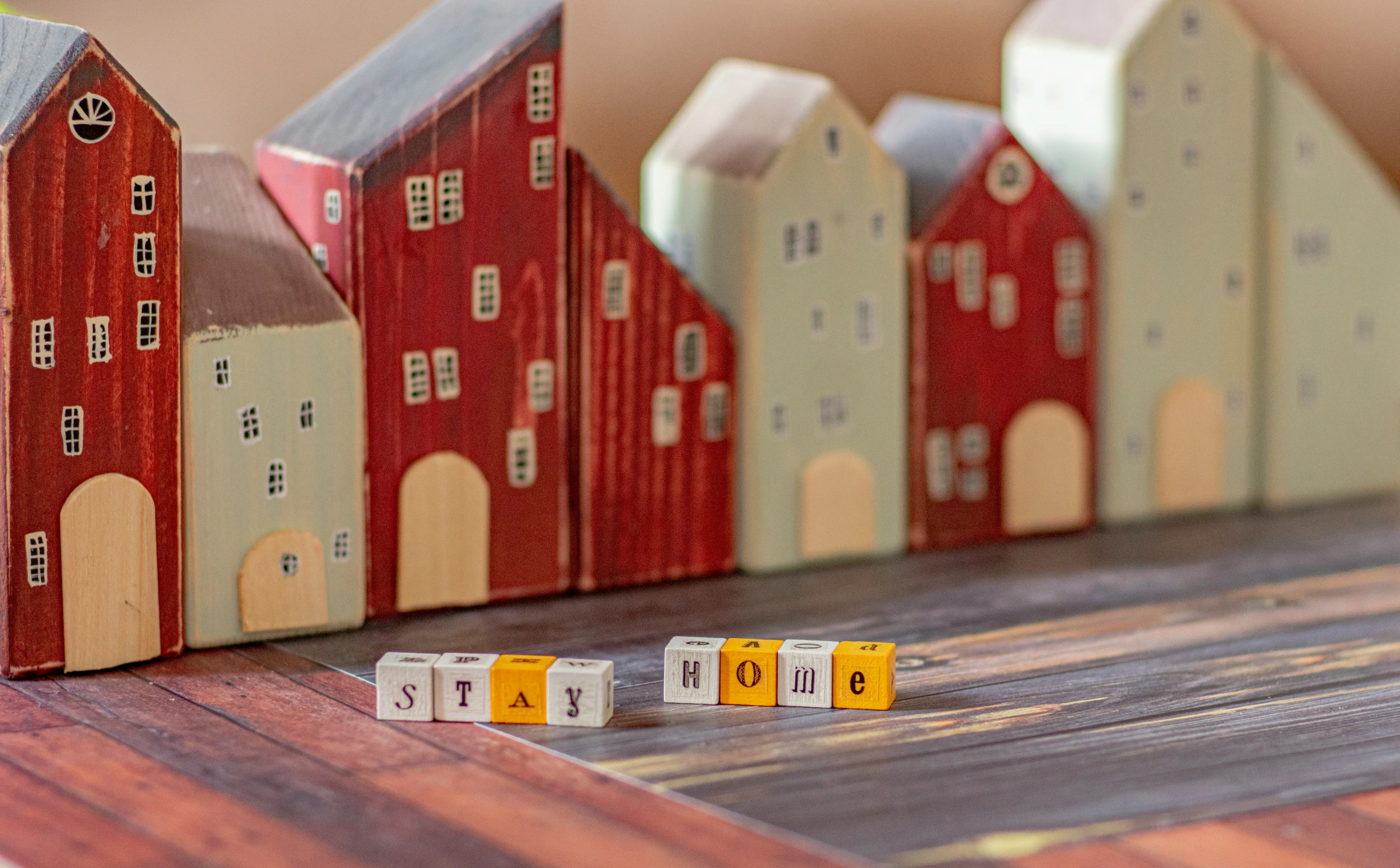 wooden building with red houses and letters on them