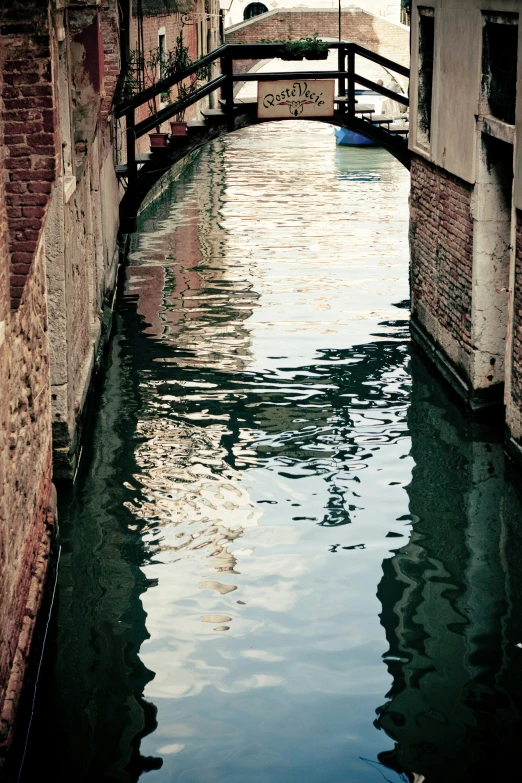 a view of a bridge over water next to buildings