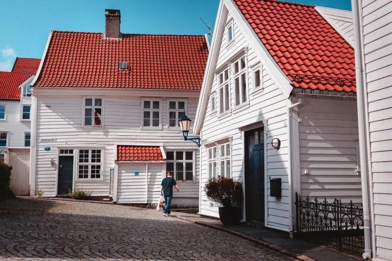 a woman stands in front of an old house