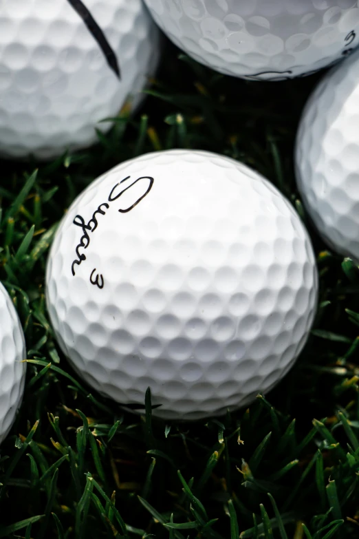 a close up of a lot of white golf balls