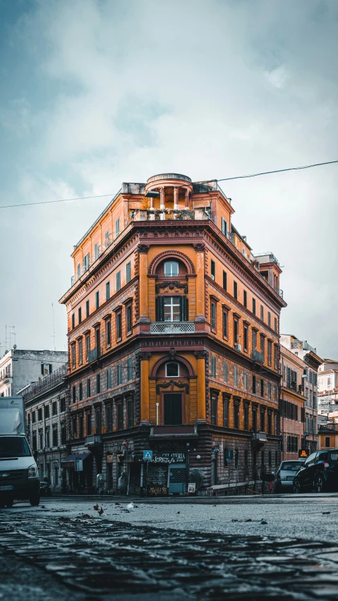 the corner of a large building with a sky background