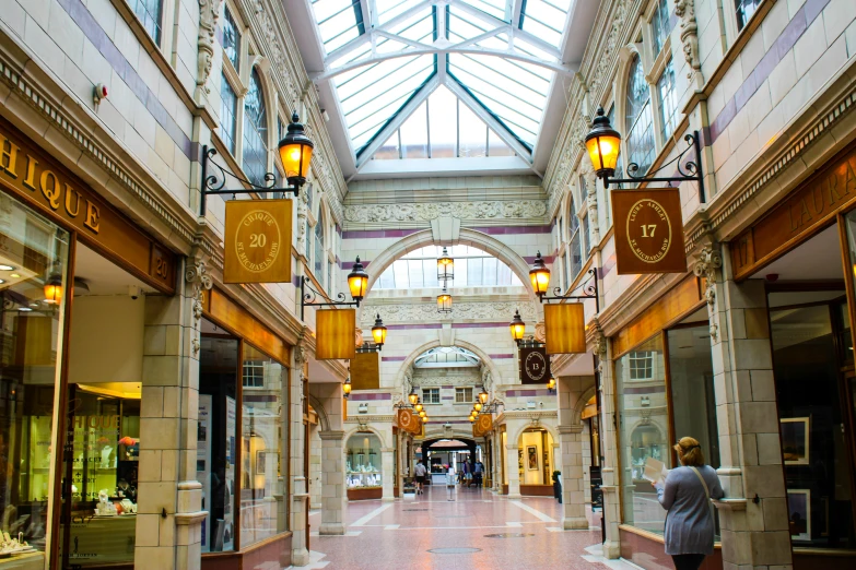 a large building with a lot of windows and people walking down the walkway