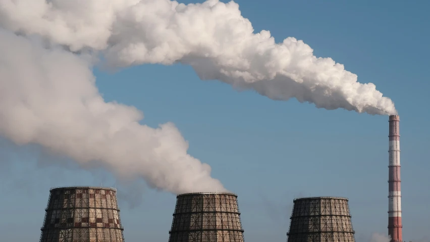 a factory with a lot of smoke pouring out