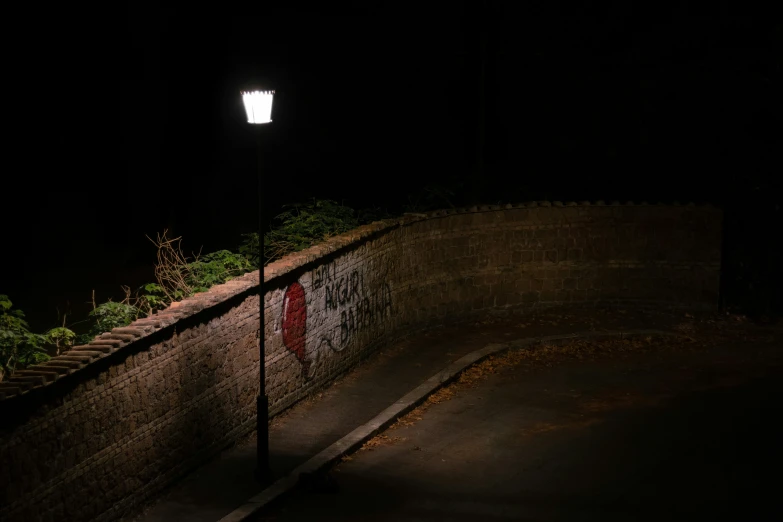 a dark po with street light on over a small hill