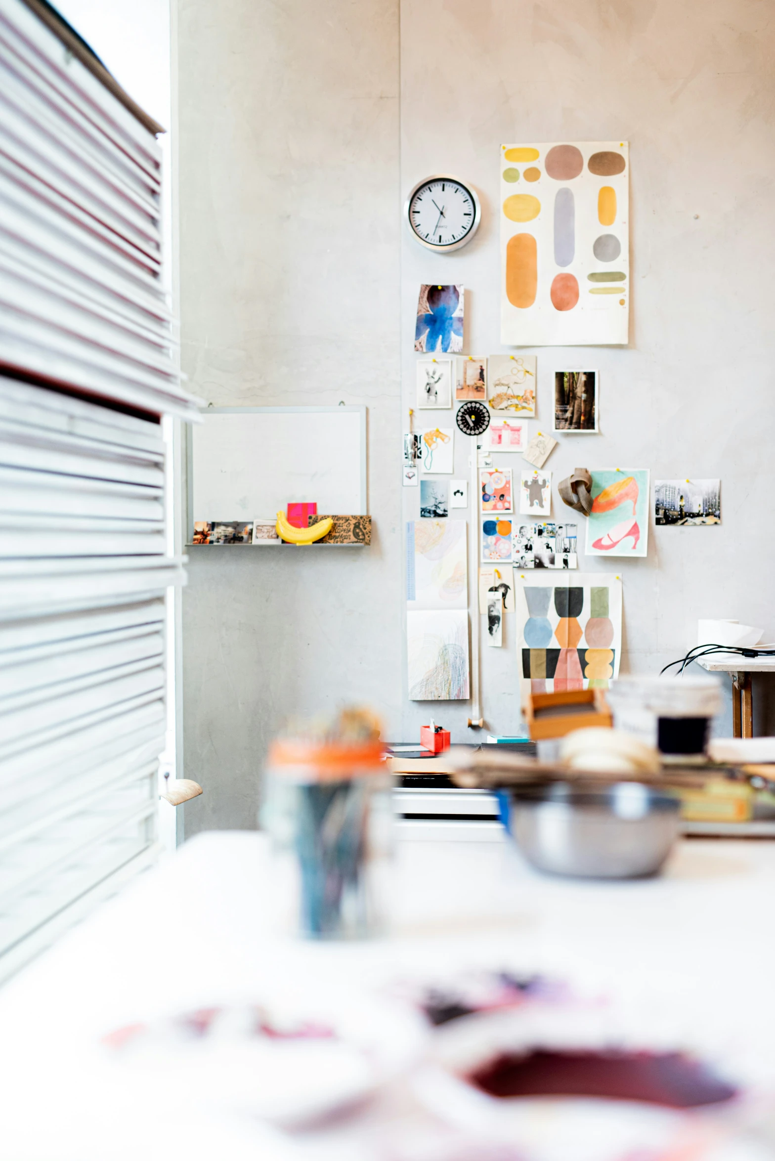 a messy room with posters, pictures and dishes